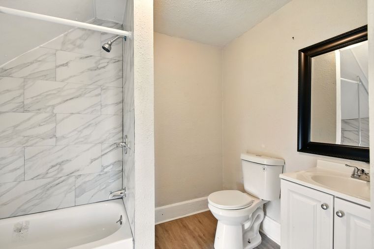 A bathroom with a toilet , sink , and shower.