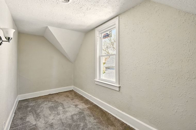 There is a window in the corner of the room.