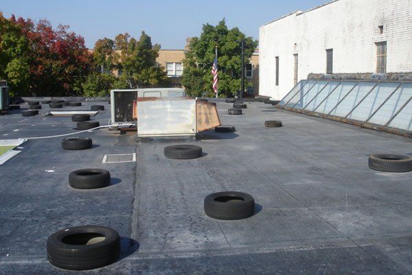 Flat Roof With Tires — Candler, NC — ARS Construction Service