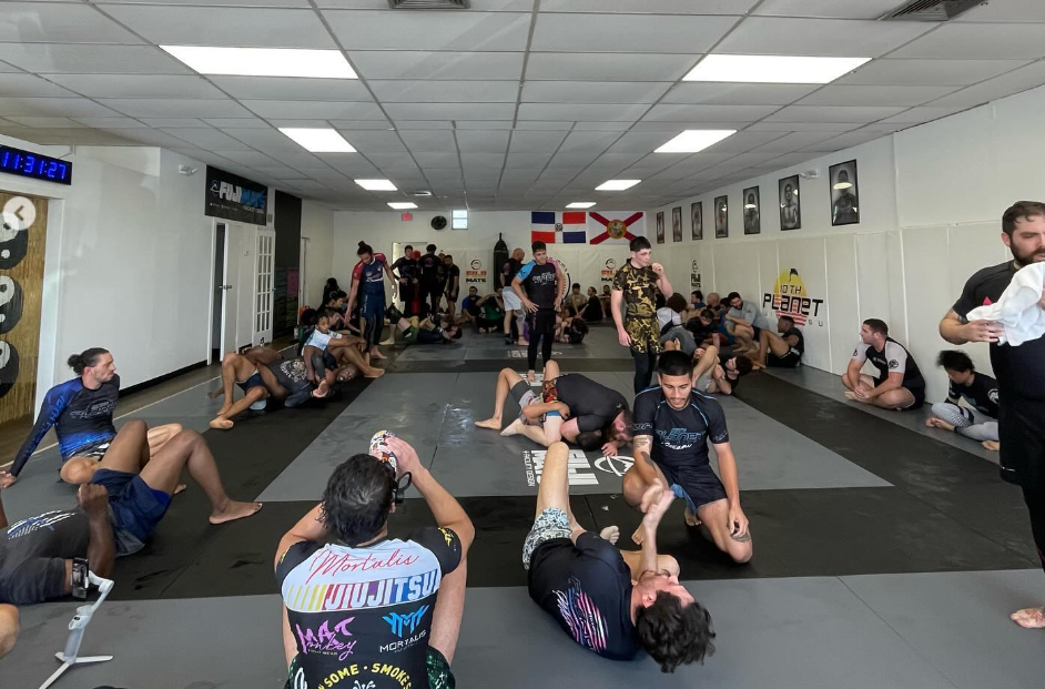 Adults drilling No-Gi grappling at 10th Planet Jiu-Jitsu Miami near Miramar, FL, building fitness and self-defense skills.