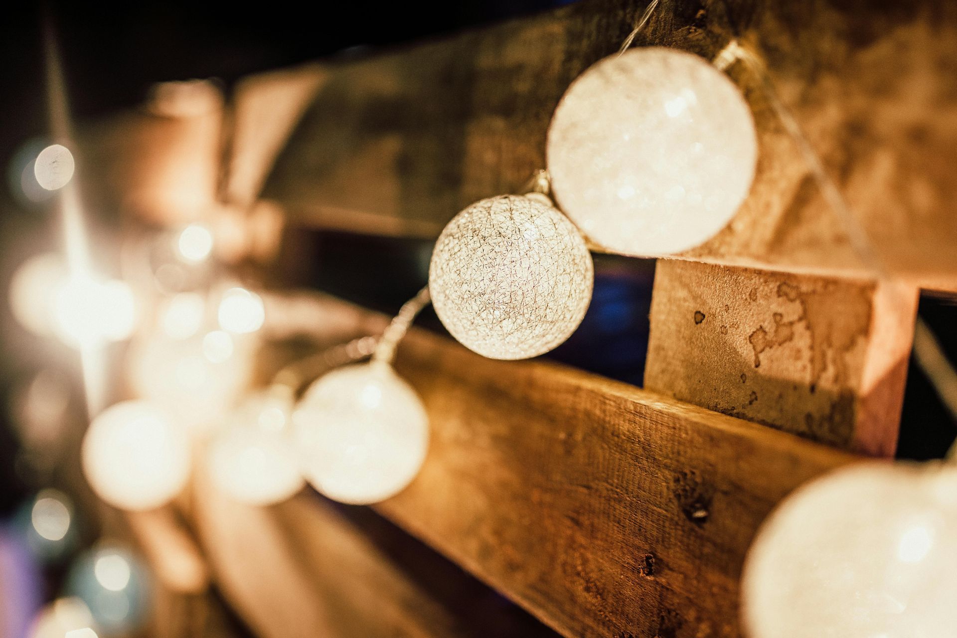 A string of lights hanging from a wooden pallet.