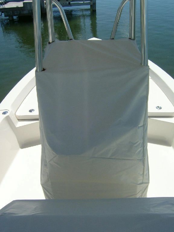 The front of a white boat with a ladder leading to the water