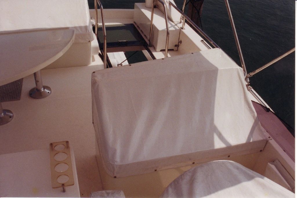 A boat with a table and chairs on the deck