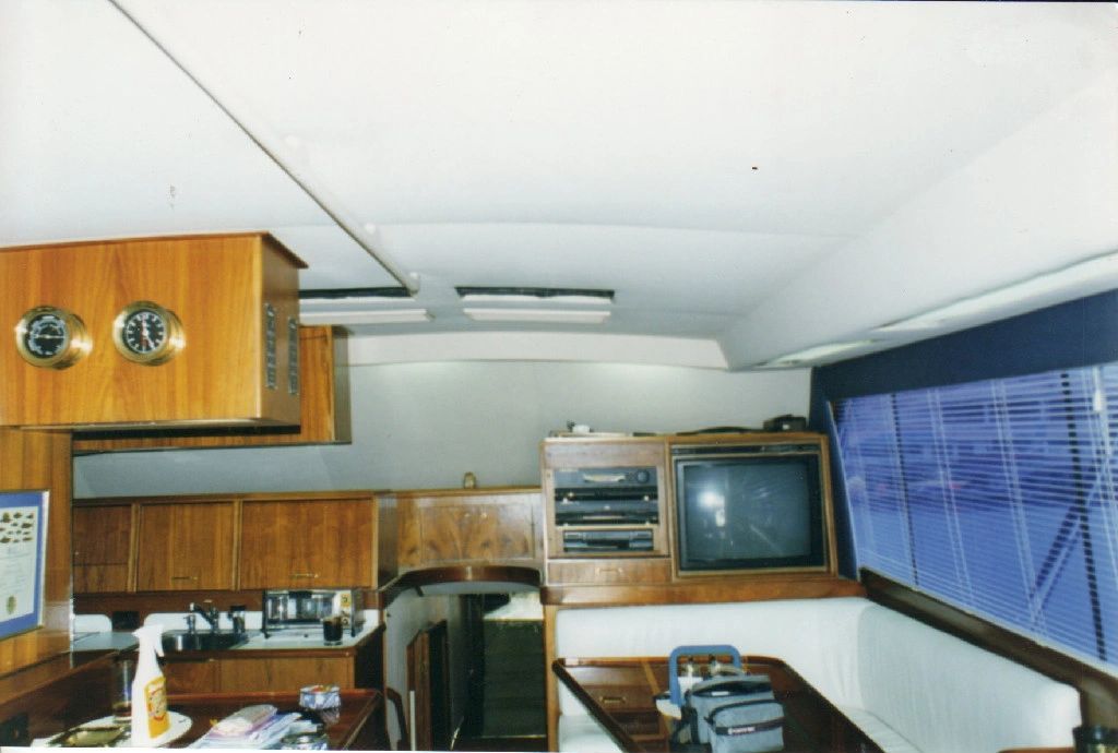 The inside of a boat with a table and a television