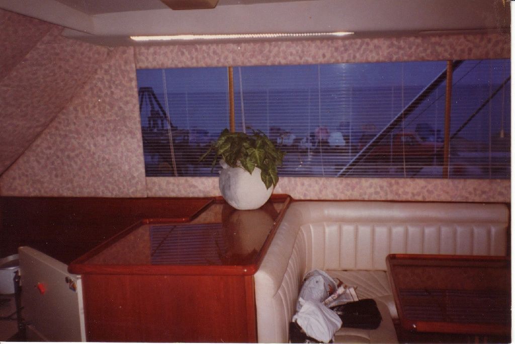 A room with a table and a window with blinds on it