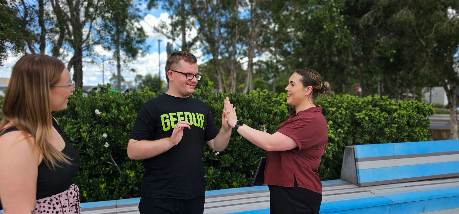 Two men are sitting next to each other with their arms crossed