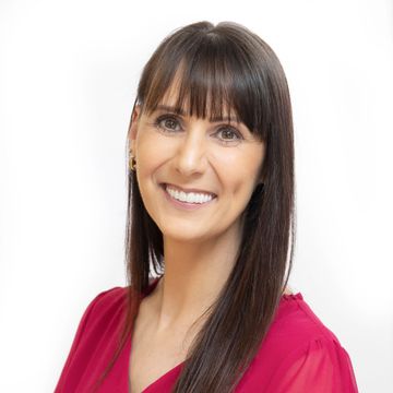 A woman wearing a blue shirt with the word coo on it