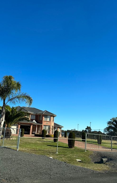 A large house with a blue sky in the background