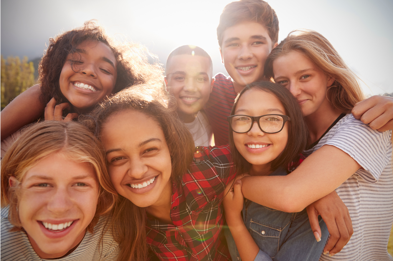 A group of young people are posing for a picture together.