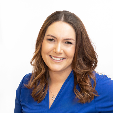 A woman in a blue shirt is smiling in a purple circle