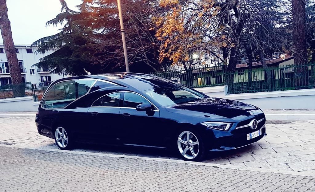 Un'auto nera è parcheggiata sul ciglio della strada.