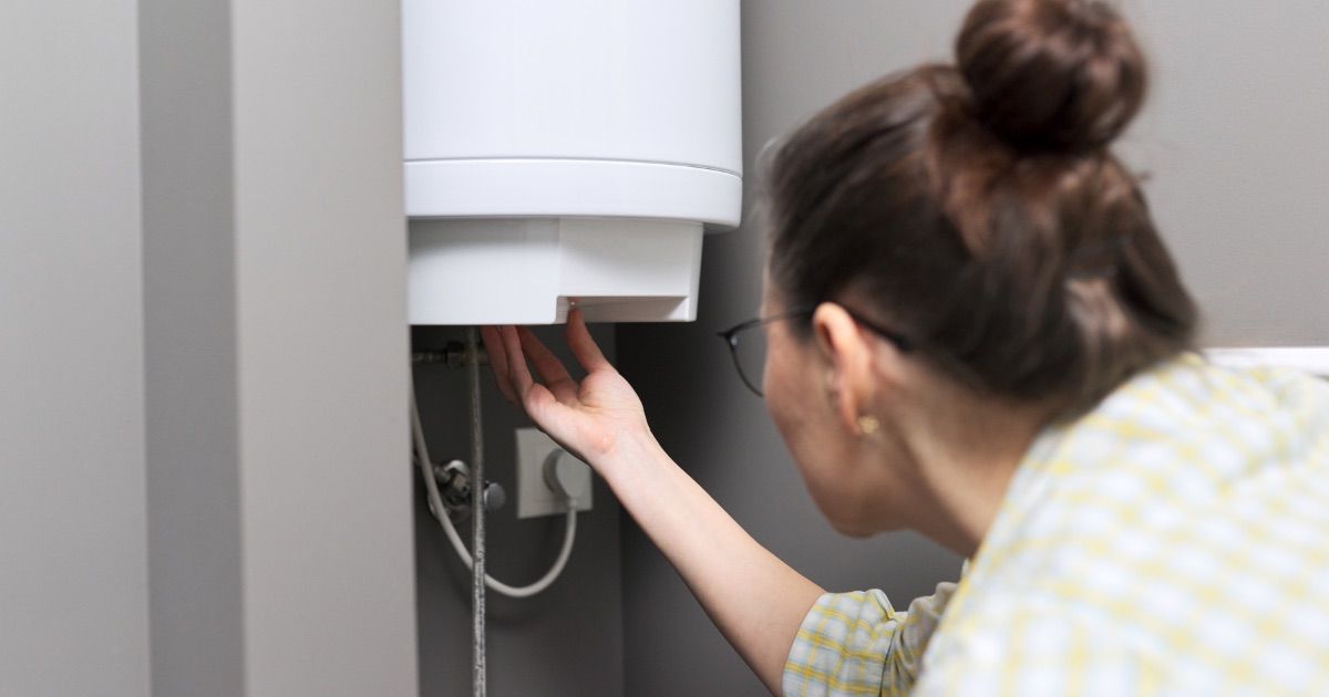 Woman working on water heater