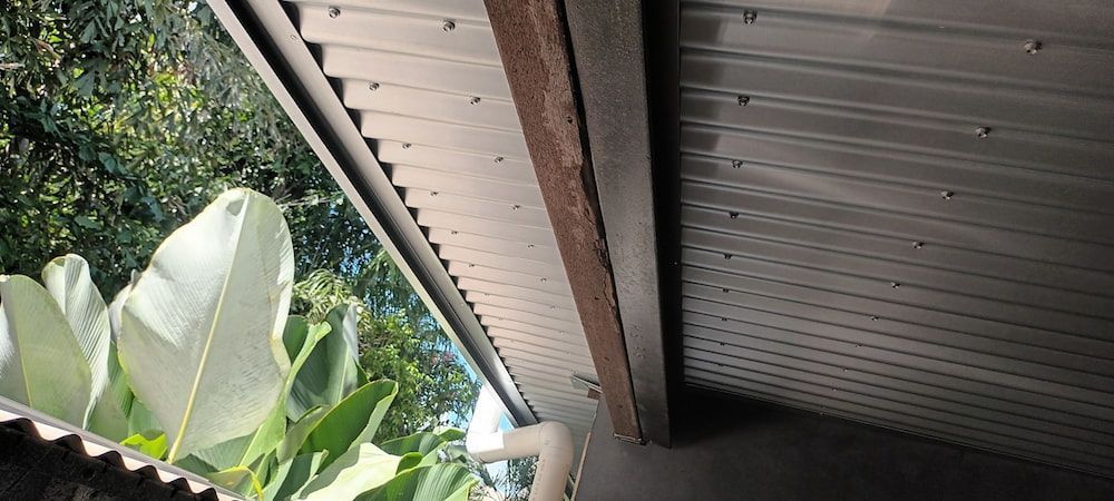 View From Below, of a Metal Roof With Wood Trim — KNG Roofing And Construction in Darwin, NT