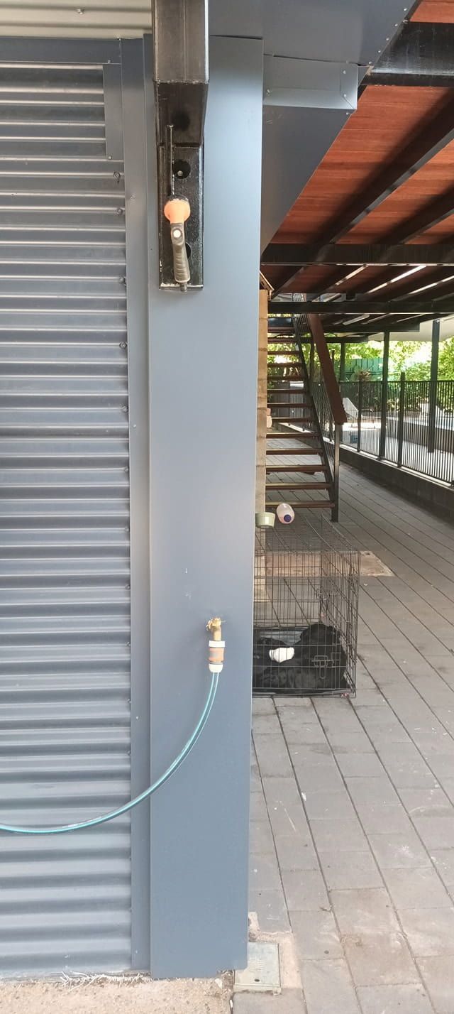 Grey Exterior With a Hose Connected to a Faucet — KNG Roofing And Construction in Darwin, NT