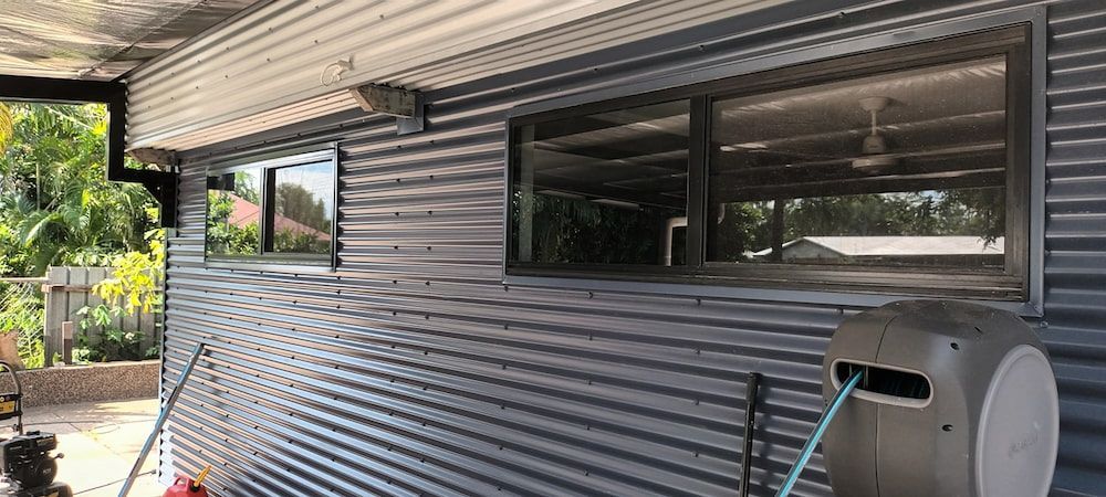 Exterior View of a Building With Corrugated Metal Siding, Windows — KNG Roofing And Construction in Darwin, NT
