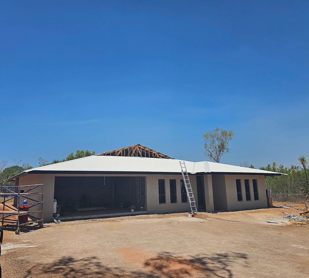 House Under Construction With Completed Roof and Open Garage — KNG Roofing And Construction in Darwin, NT