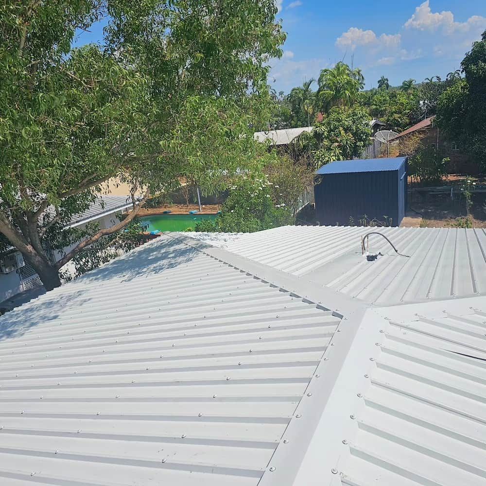 White Metal Roof With a Surrounding Green Landscape — KNG Roofing And Construction in Darwin, NT