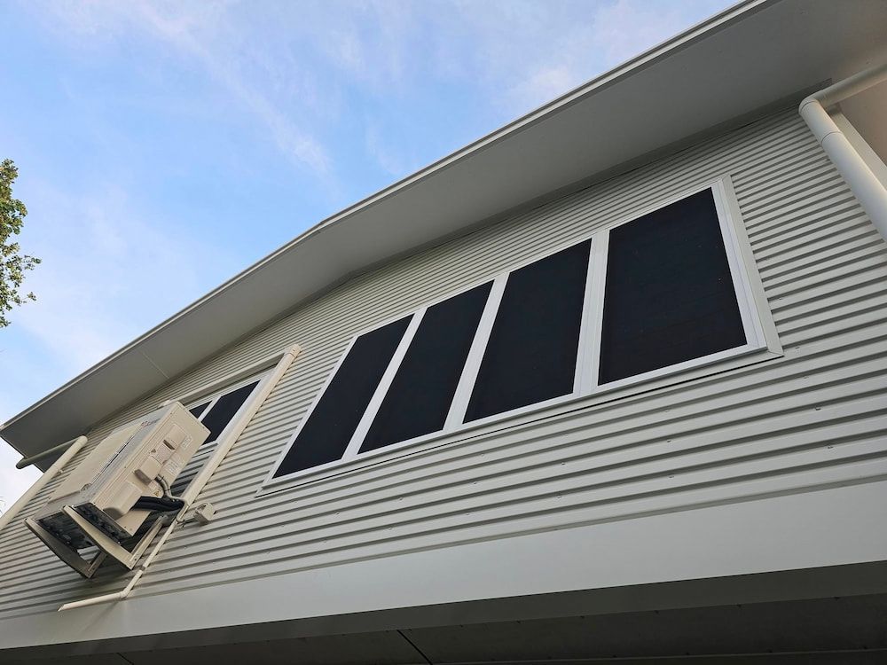 Extension of a Light-coloured Building With Several Dark Window Panes — KNG Roofing And Construction in Palmerston, NT