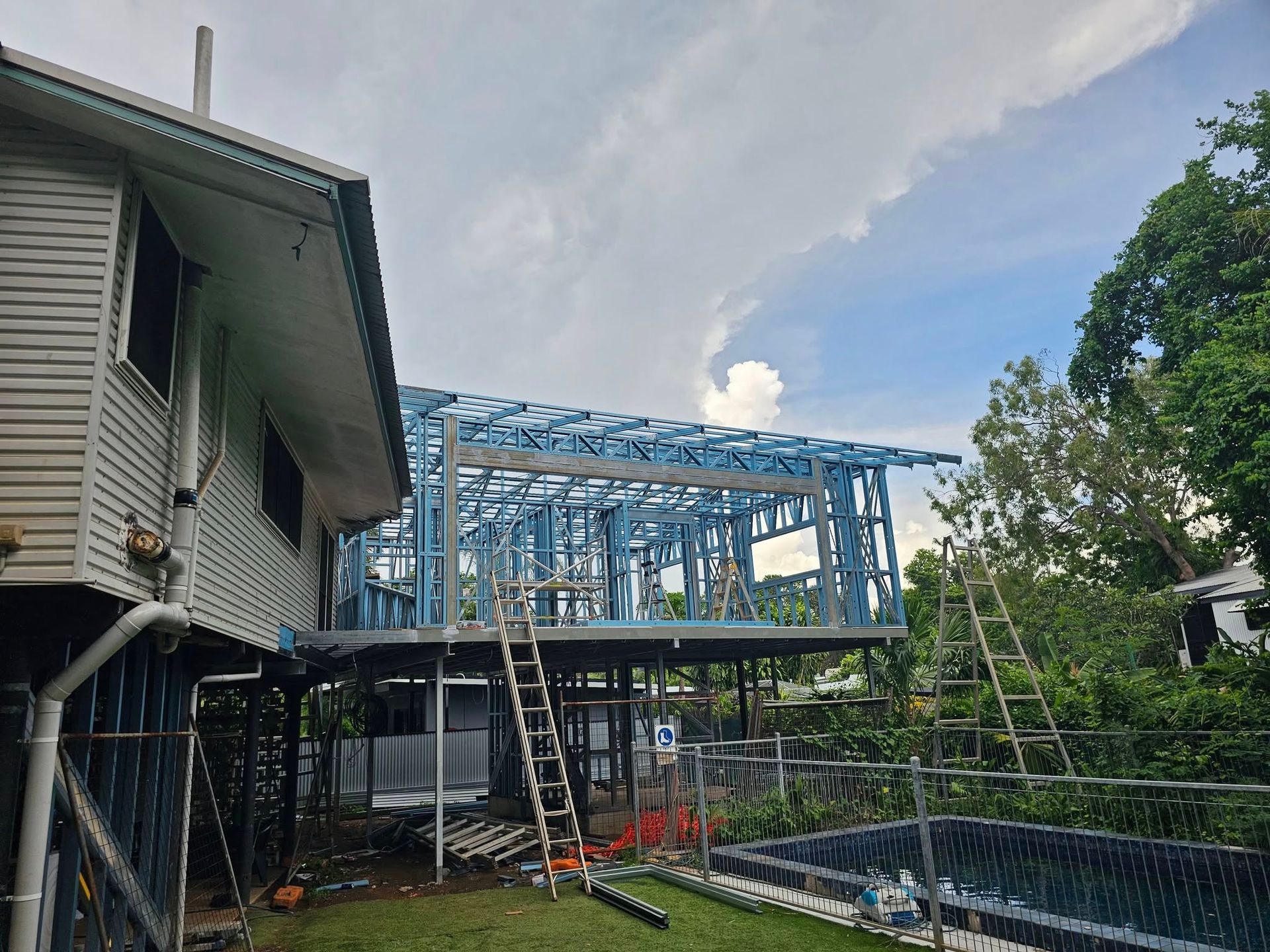 Construction Worker Walking Past a Motor on a Building Site — KNG Roofing And Construction in Darwin, NT