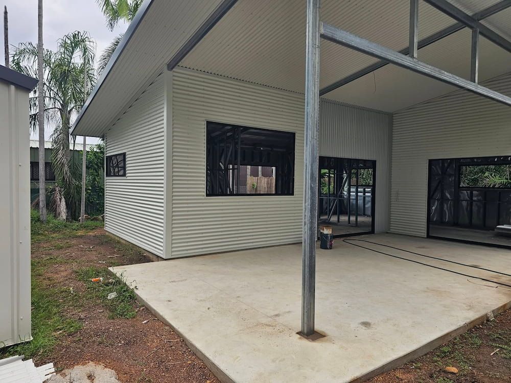 A Modern Building Under Construction With Corrugated Siding — KNG Roofing And Construction in Alice Springs, NT