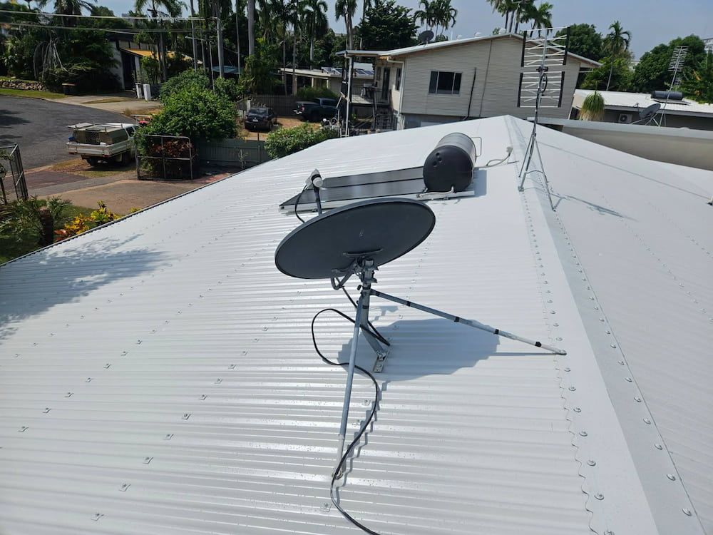 Satellite Dish on a White Corrugated Roof With Water Heater — KNG Roofing And Construction in Tiwi, NT