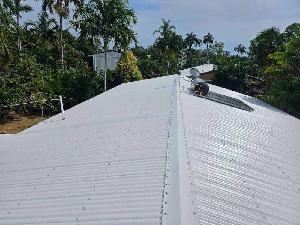 White Corrugated Metal Roof With Solar Panel — KNG Roofing And Construction in Gove, NT