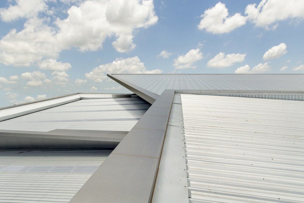 Metal Roof Panels Under a Partly Cloudy Blue Sky — KNG Roofing And Construction in Tiwi, NT
