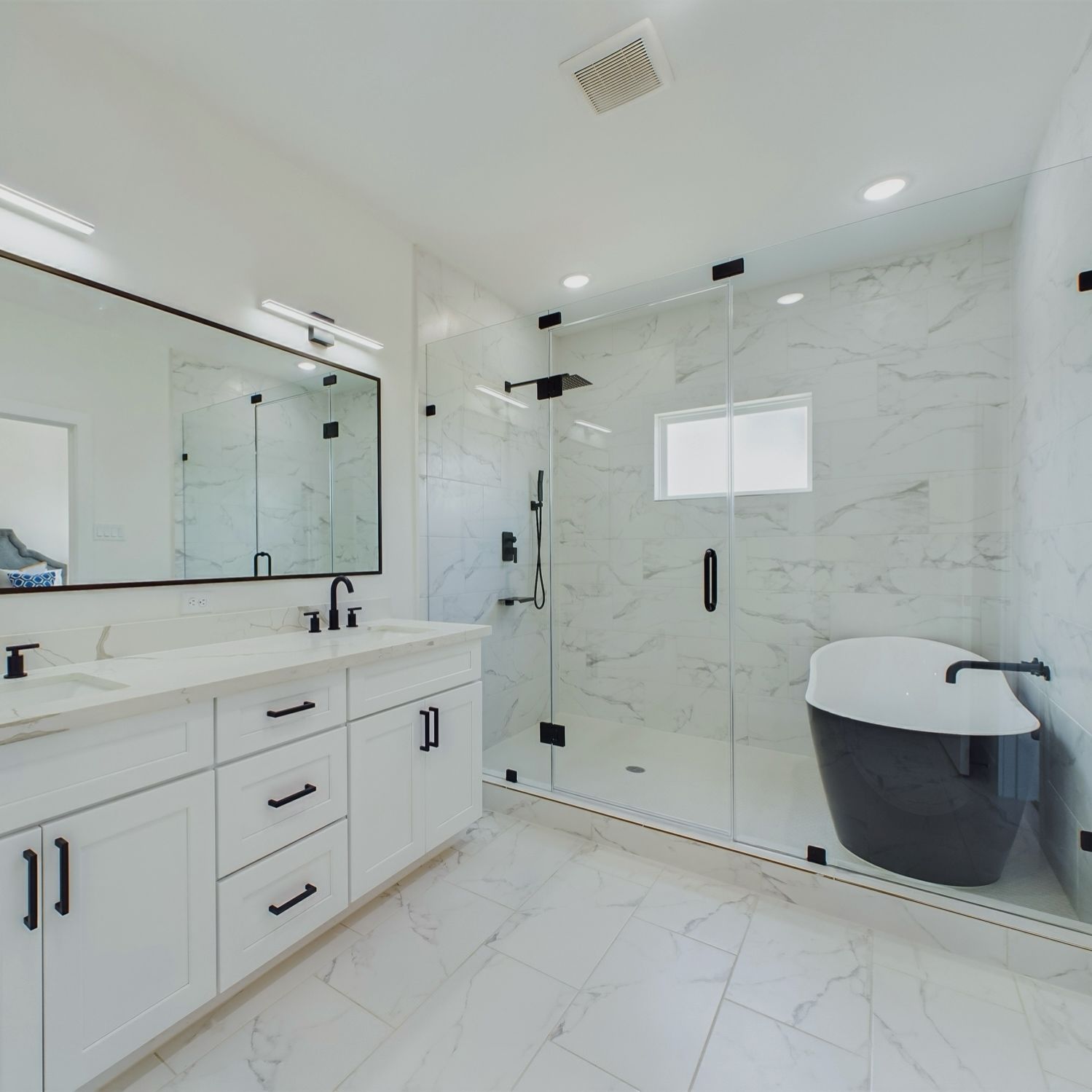White bathroom with a marble-look shower, black accents, and a black soaking tub.