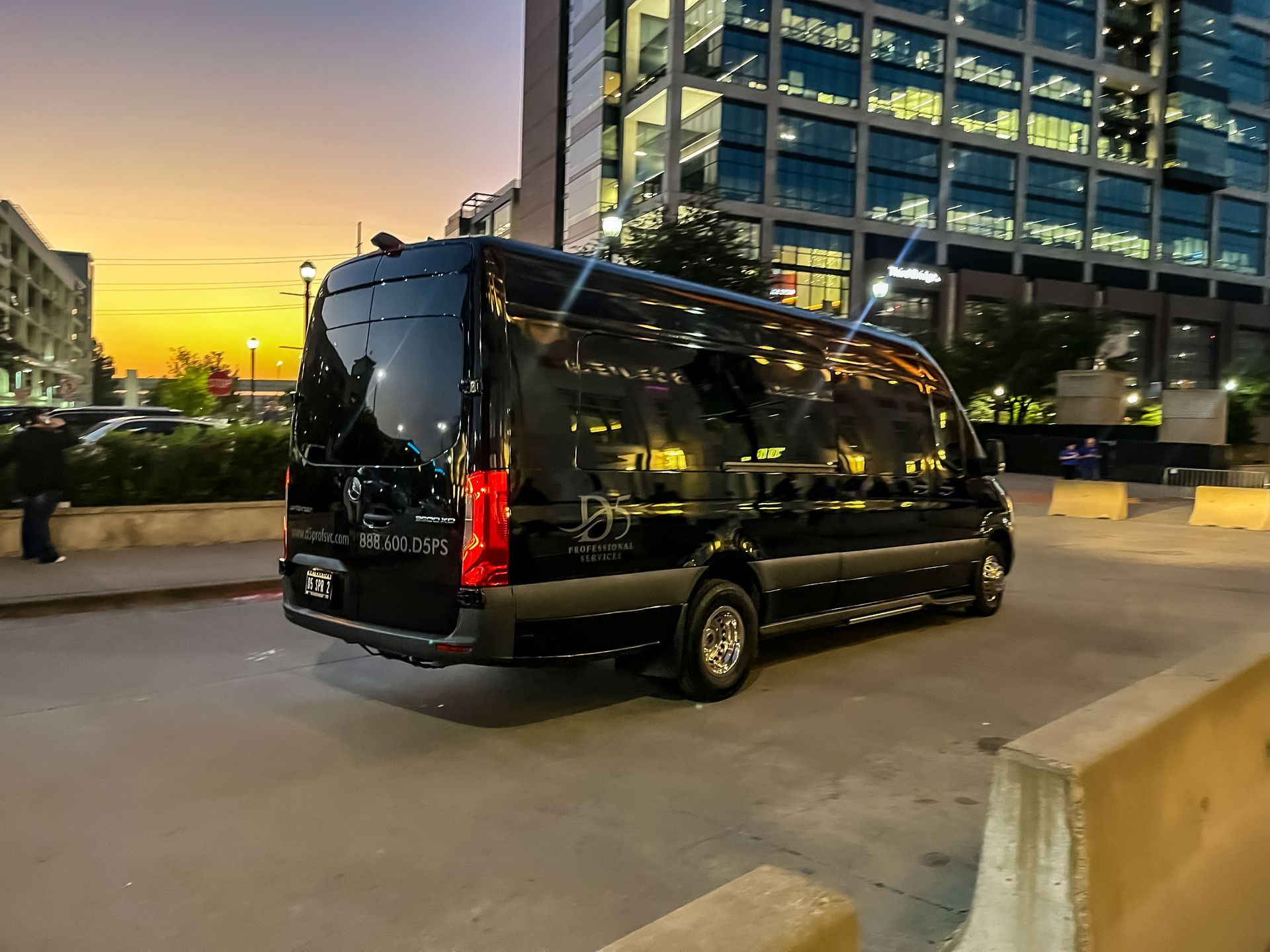 A black mercedes benz s class is parked in a parking lot.