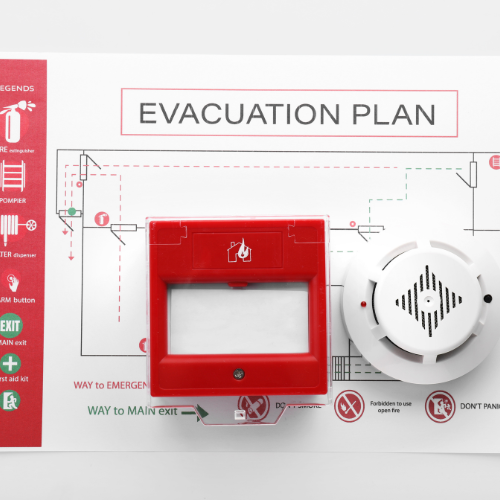 Un plan d'évacuation avec un bouton rouge et un détecteur de fumée