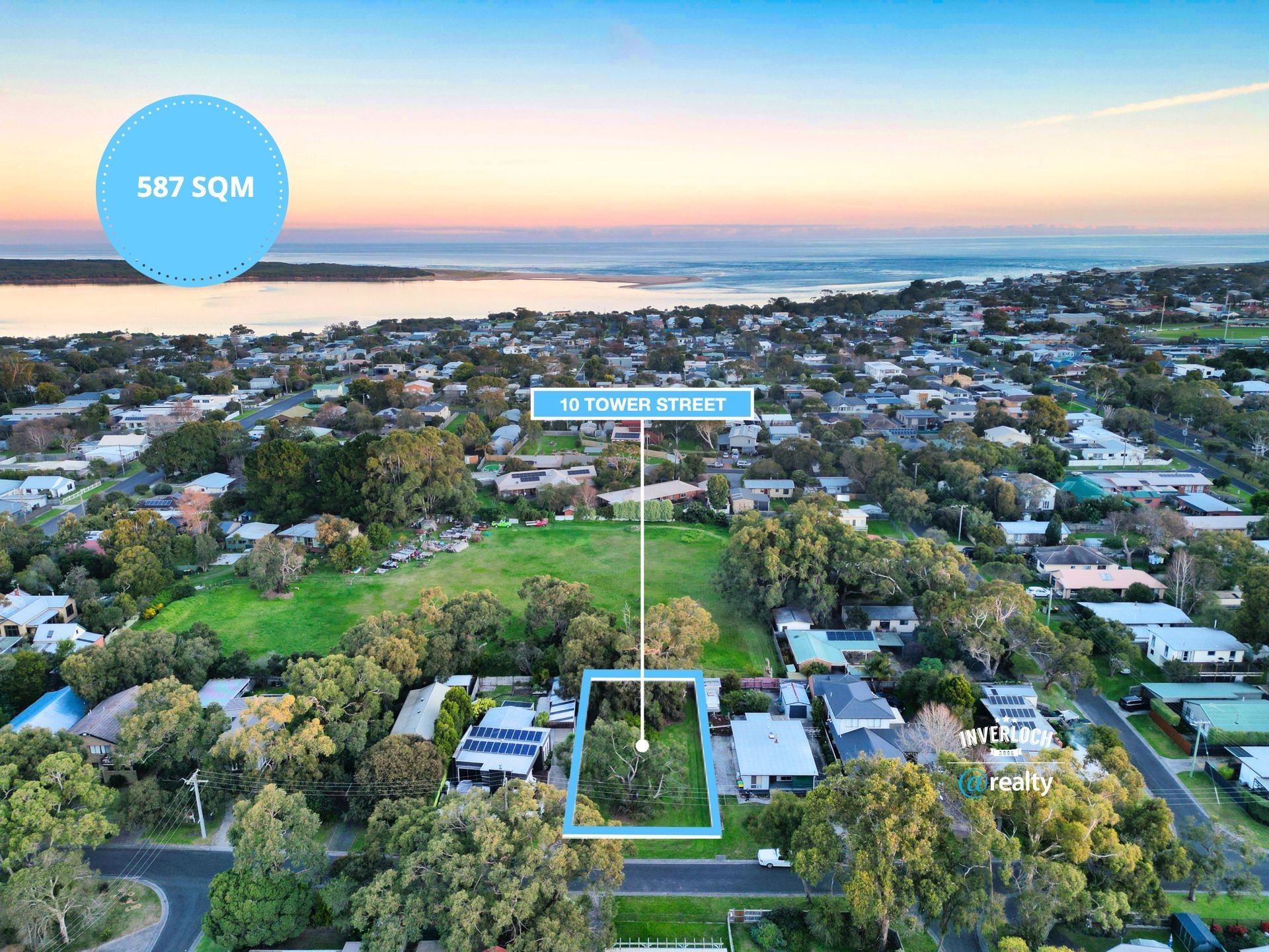 An aerial view of a residential area with a lot of trees and houses.