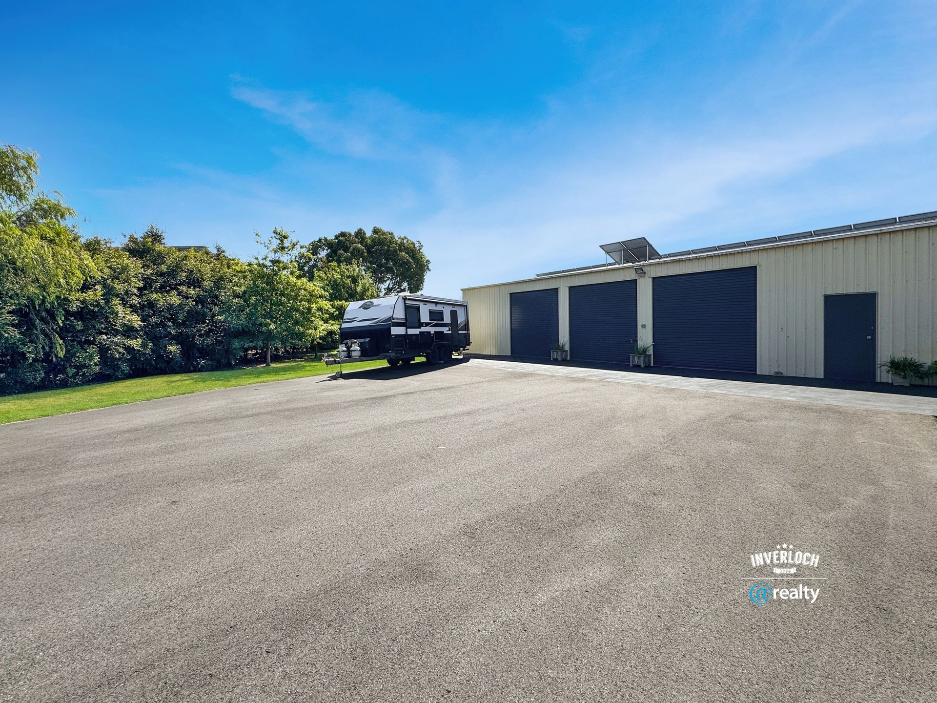 A truck is parked in a parking lot in front of a garage.