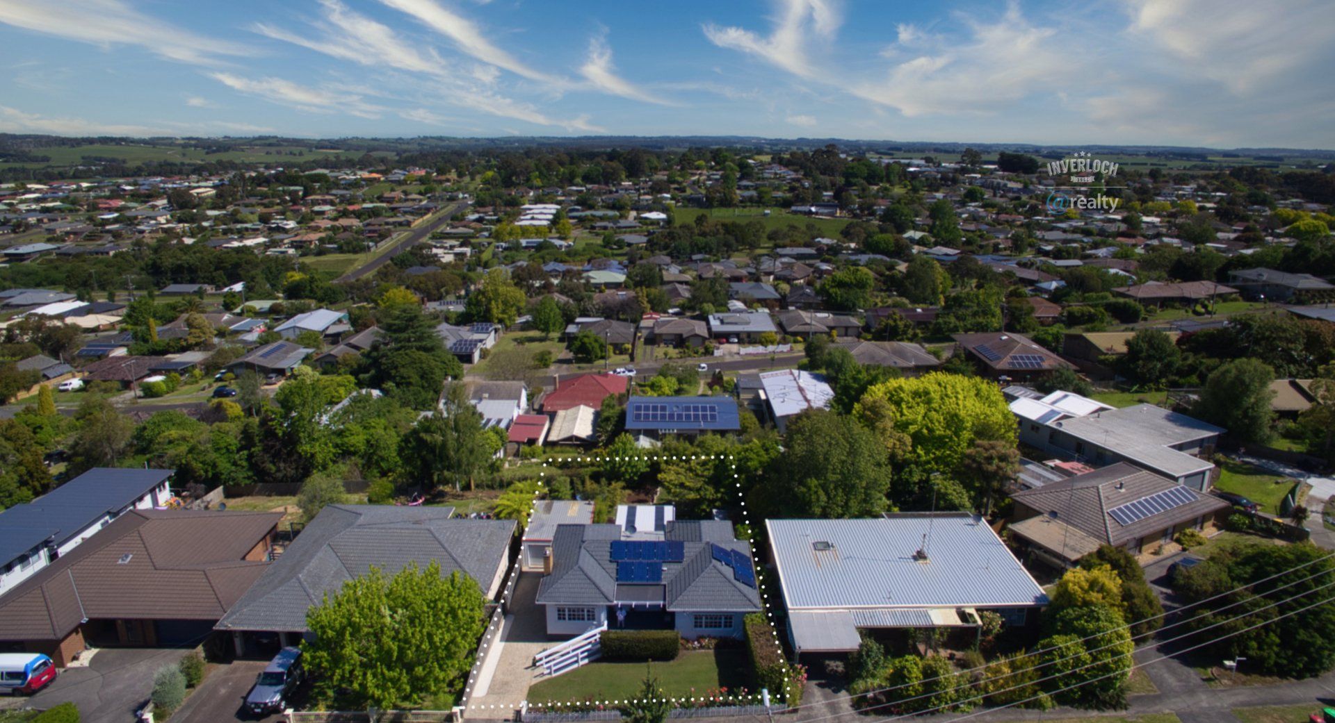 An aerial view of a residential area with lots of houses and trees.