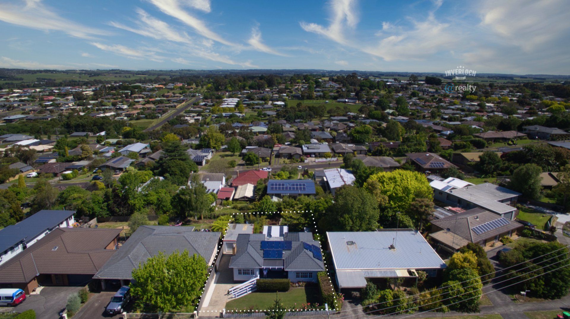 An aerial view of a residential area with lots of houses and trees.