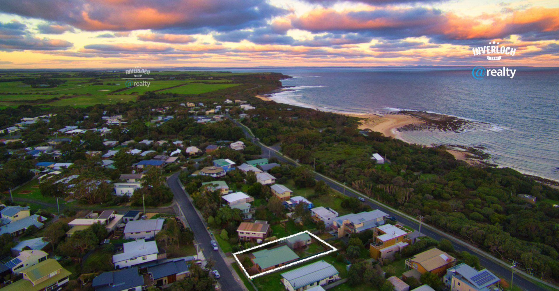 An aerial view of a residential area next to the ocean.