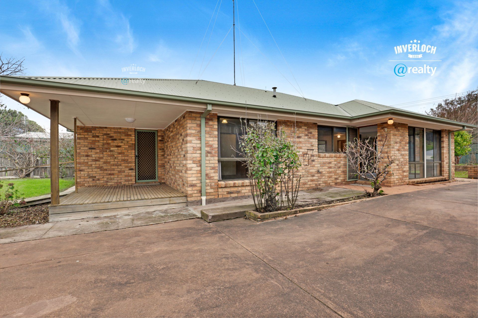 A large brick house with a green roof is for sale.