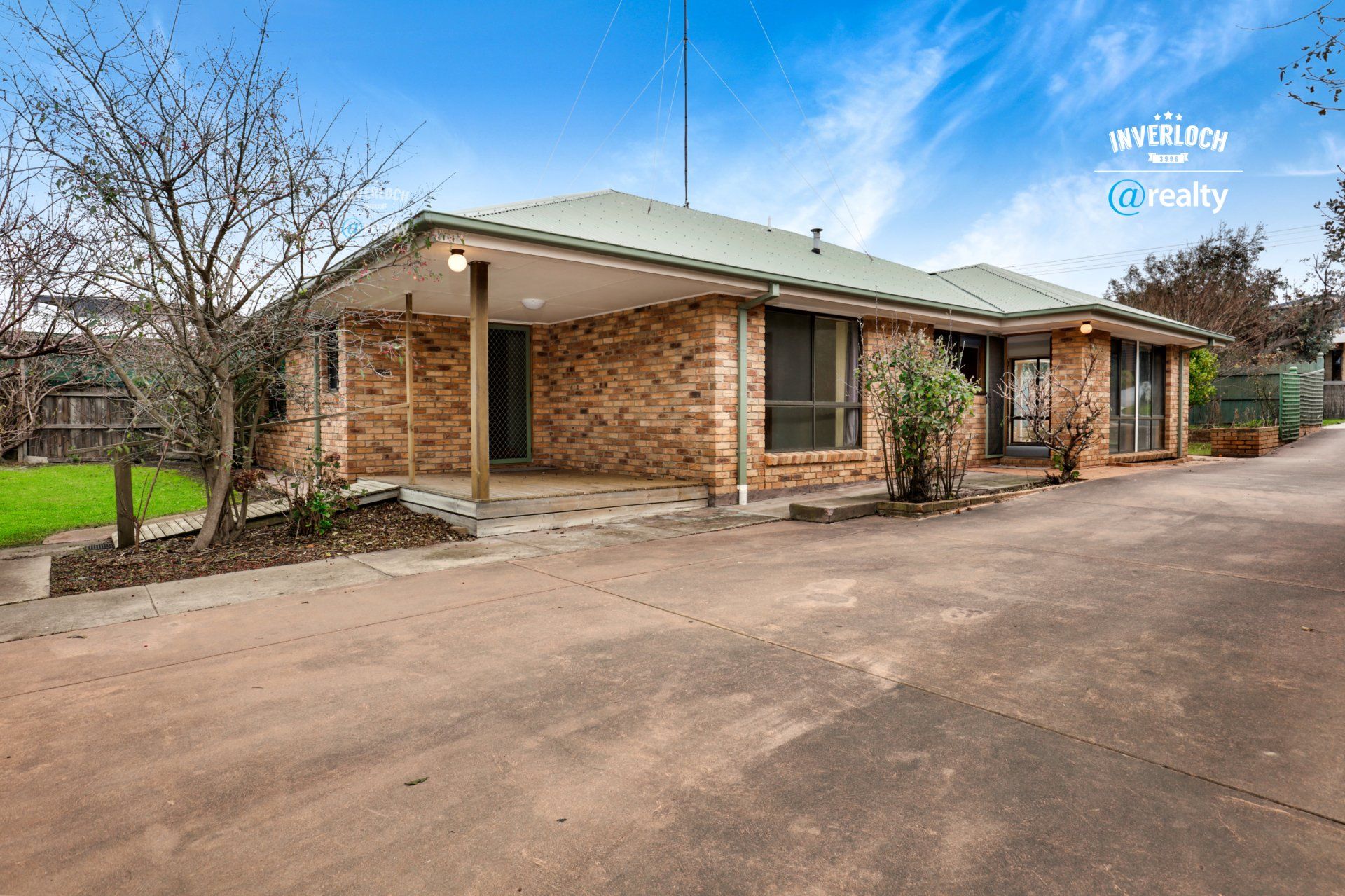 A large brick house with a green roof is for sale