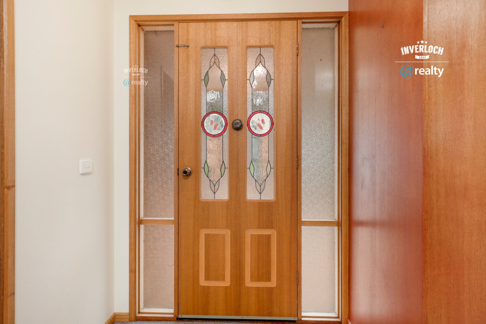 A wooden door with stained glass in a house