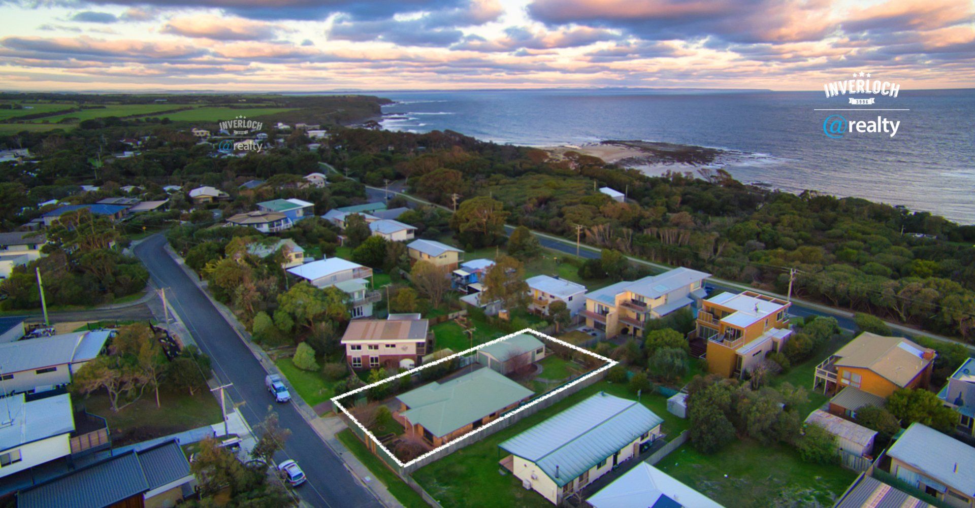 An aerial view of a residential area next to the ocean.