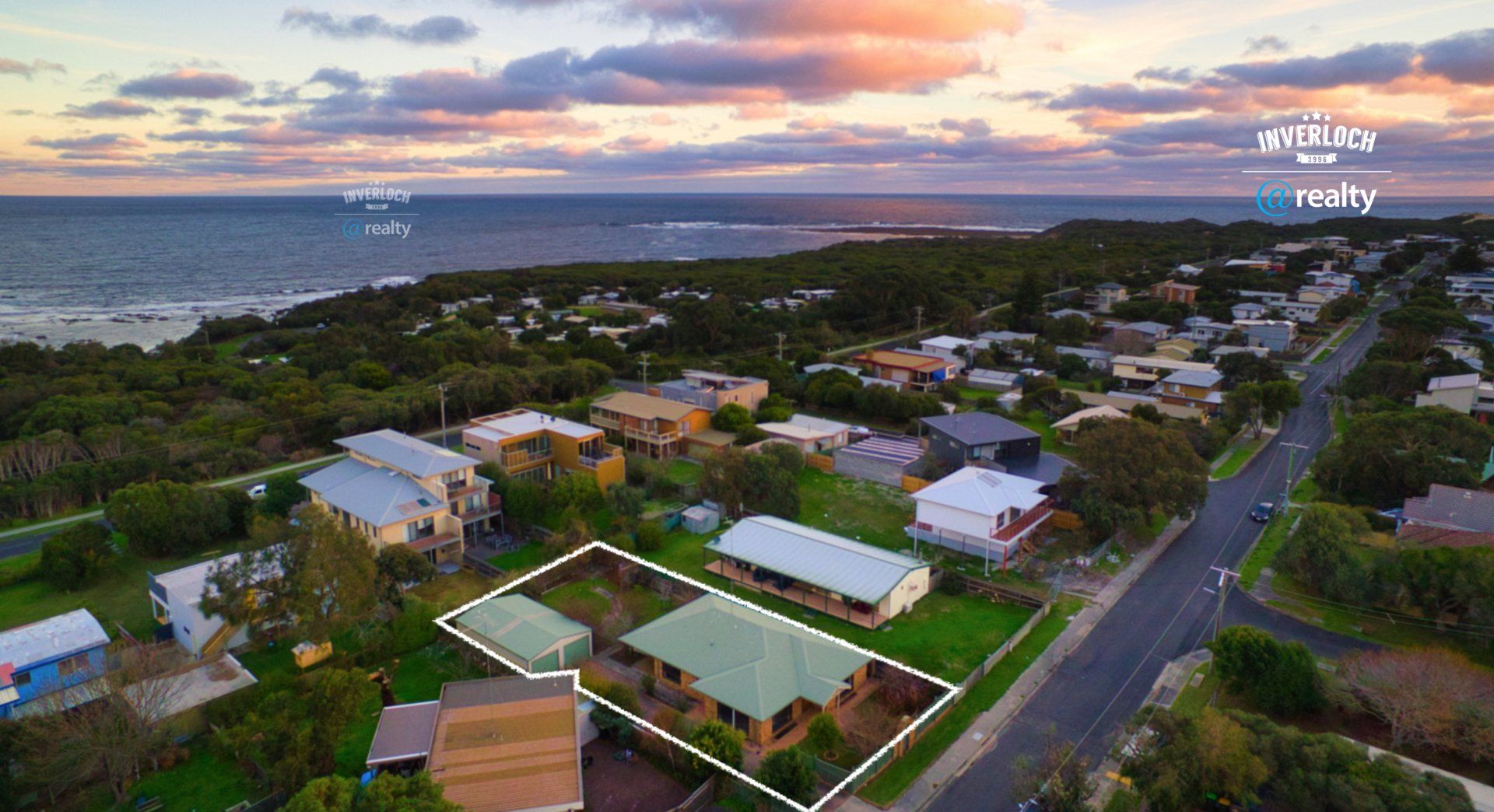 An aerial view of a residential area next to the ocean.