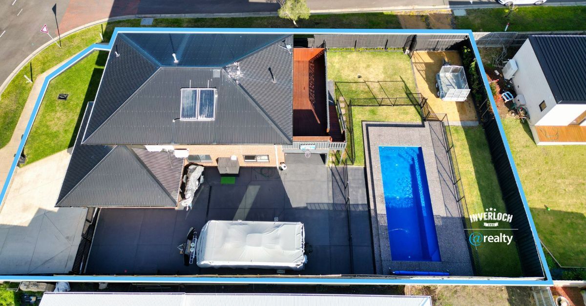 An aerial view of a house with a swimming pool