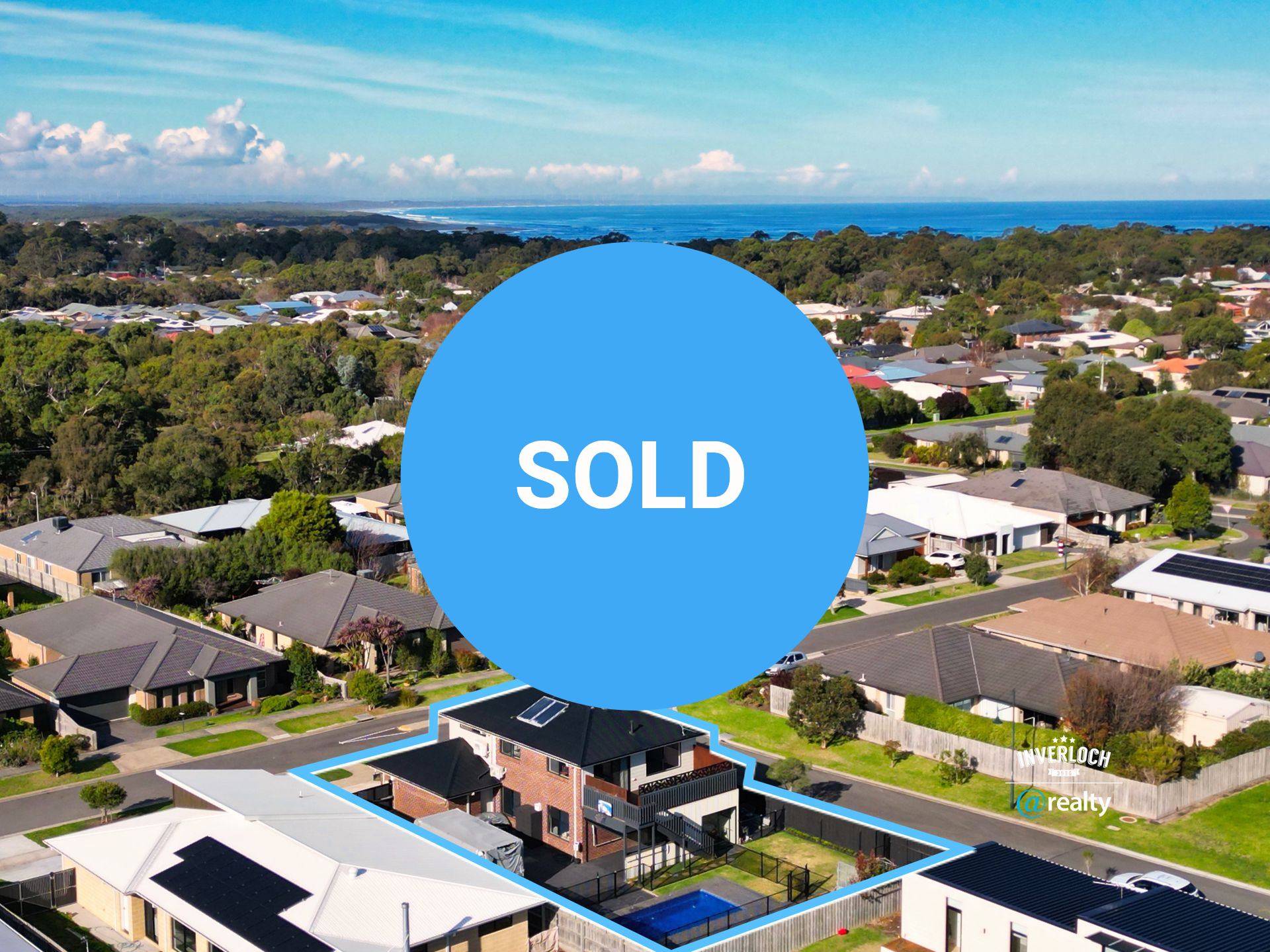 An aerial view of a residential area with a house in the middle.