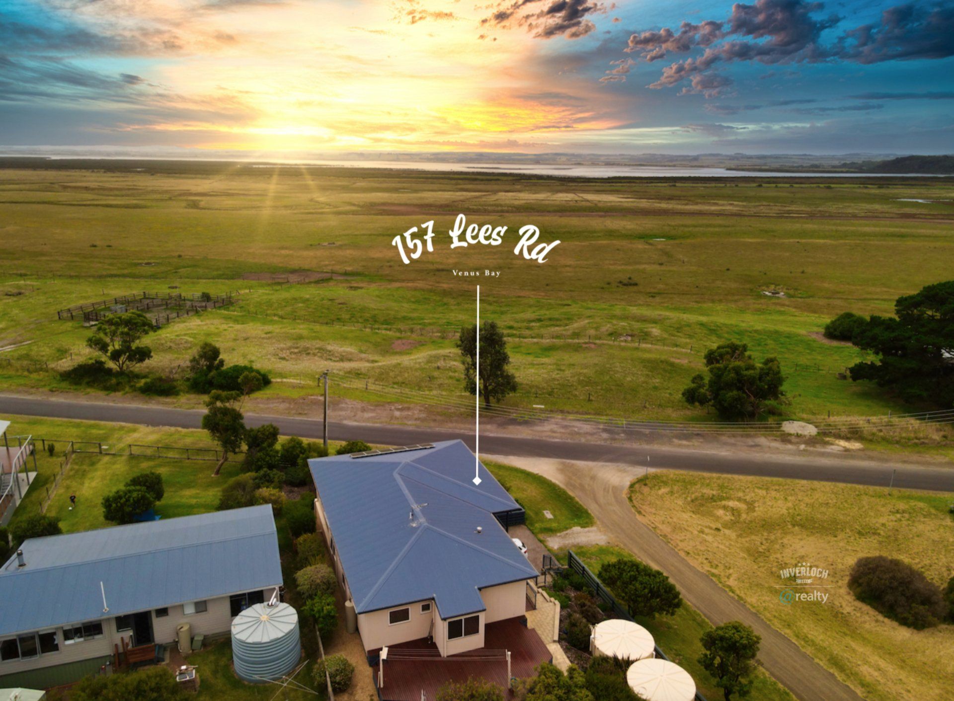 An aerial view of a house in the middle of a field.