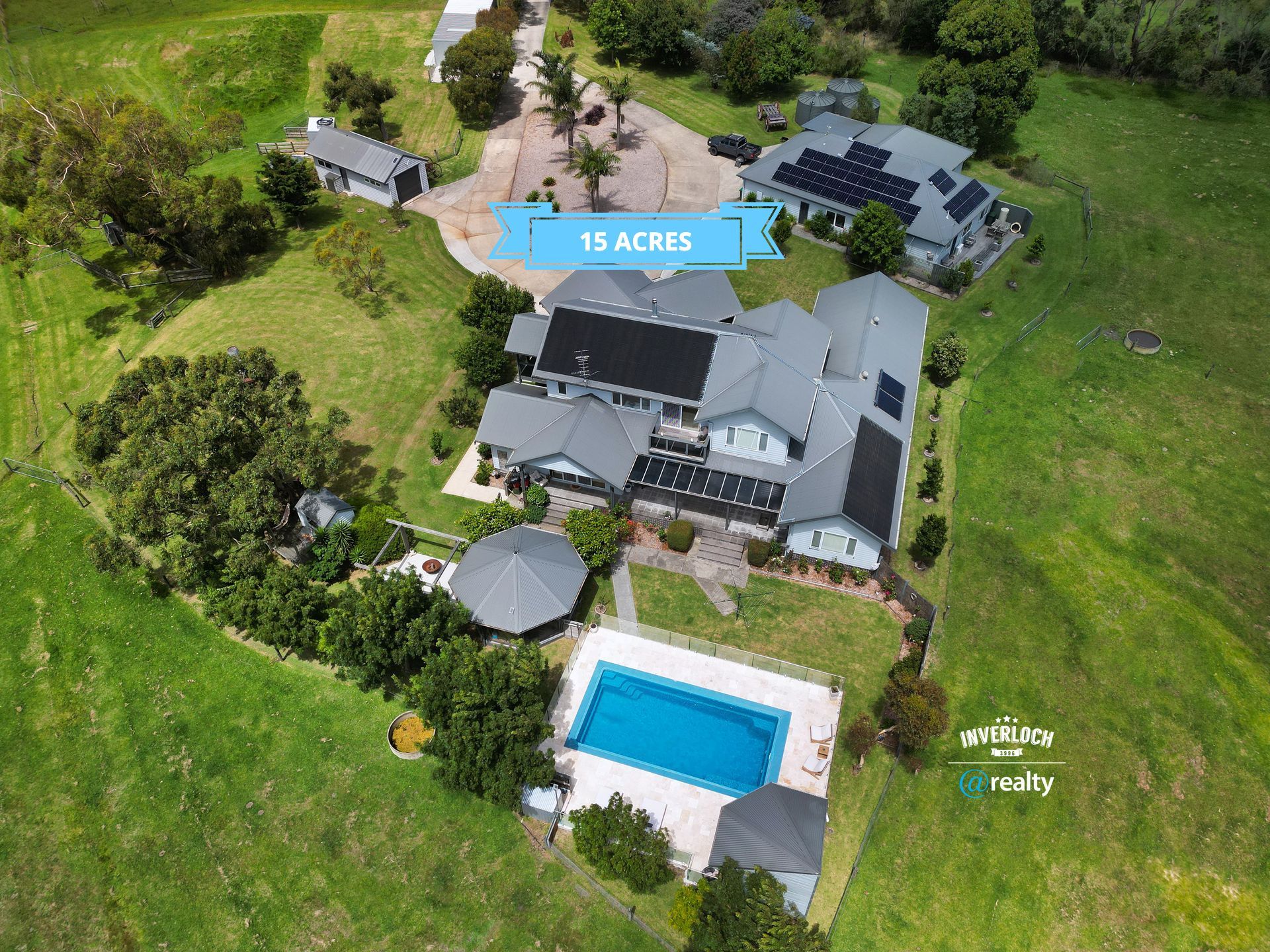 An aerial view of a large house with a swimming pool