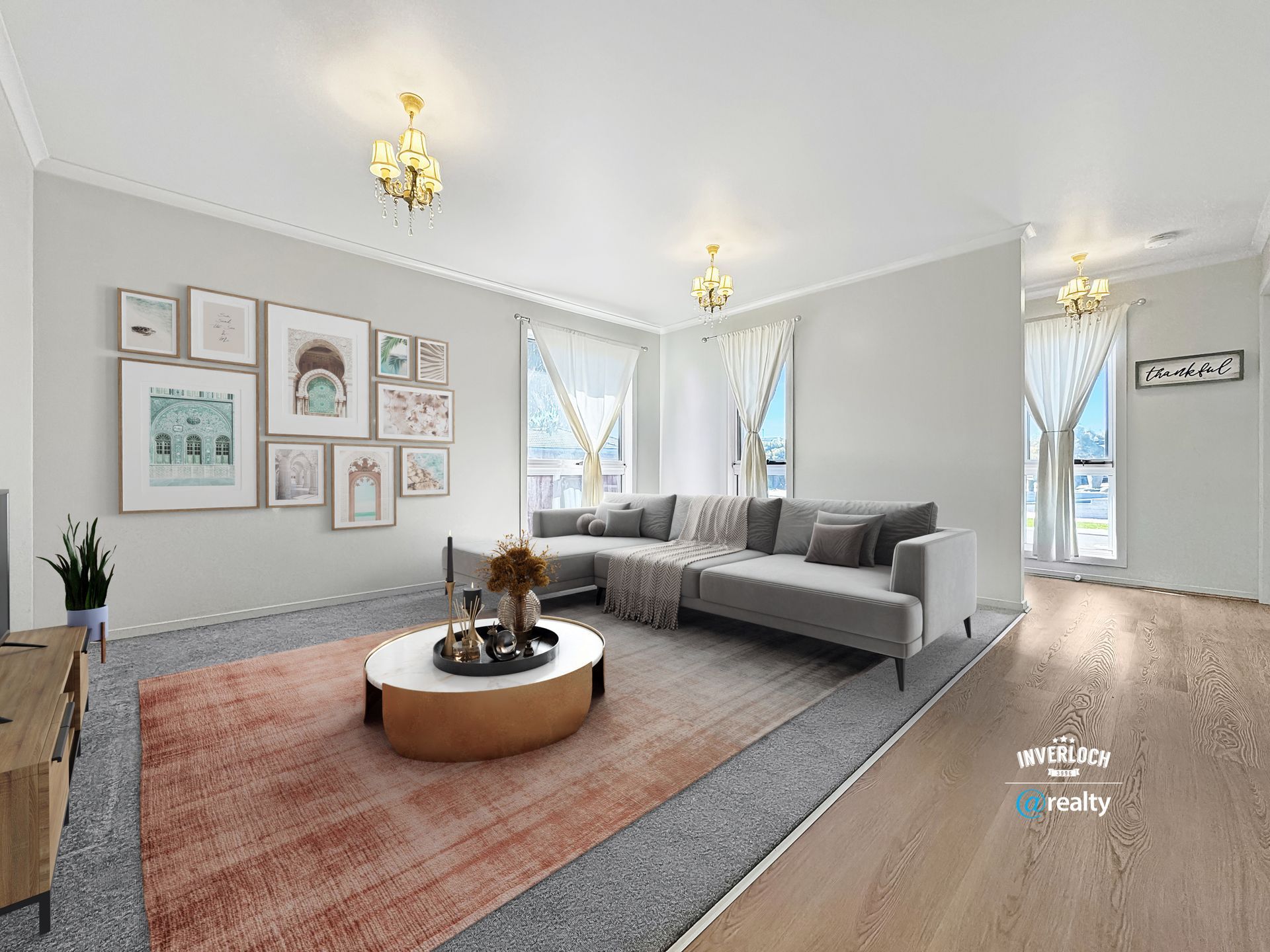 A living room with a couch , coffee table , and pictures on the wall.