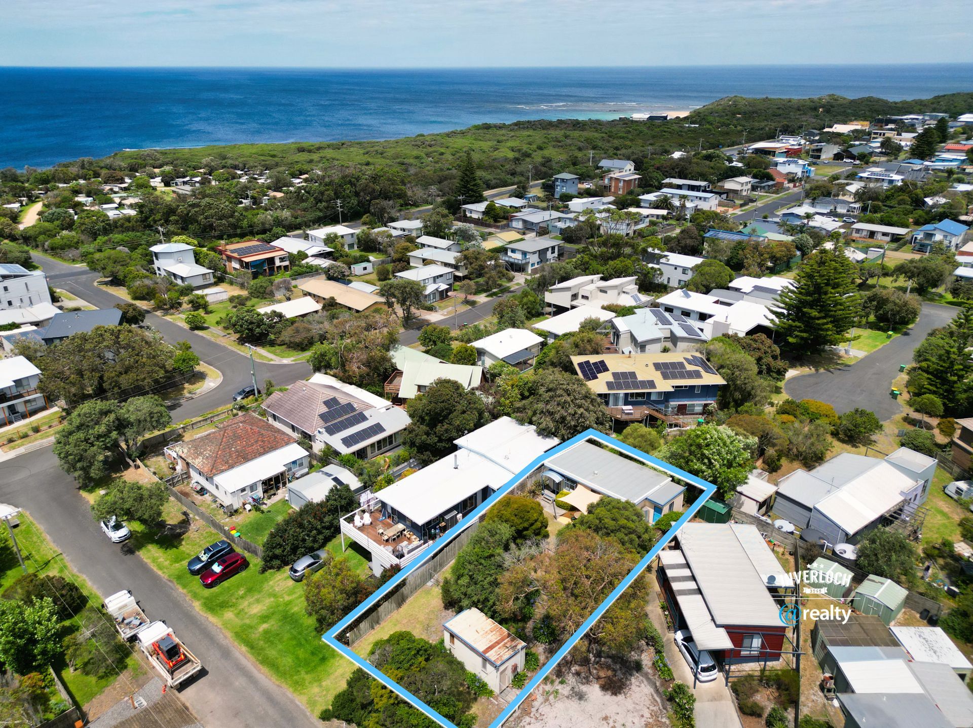 An aerial view of a residential area next to the ocean.