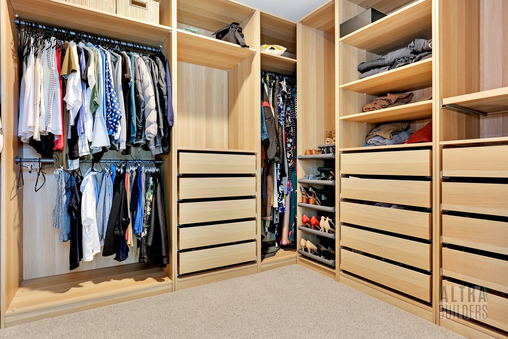 A walk in closet filled with lots of clothes and drawers
