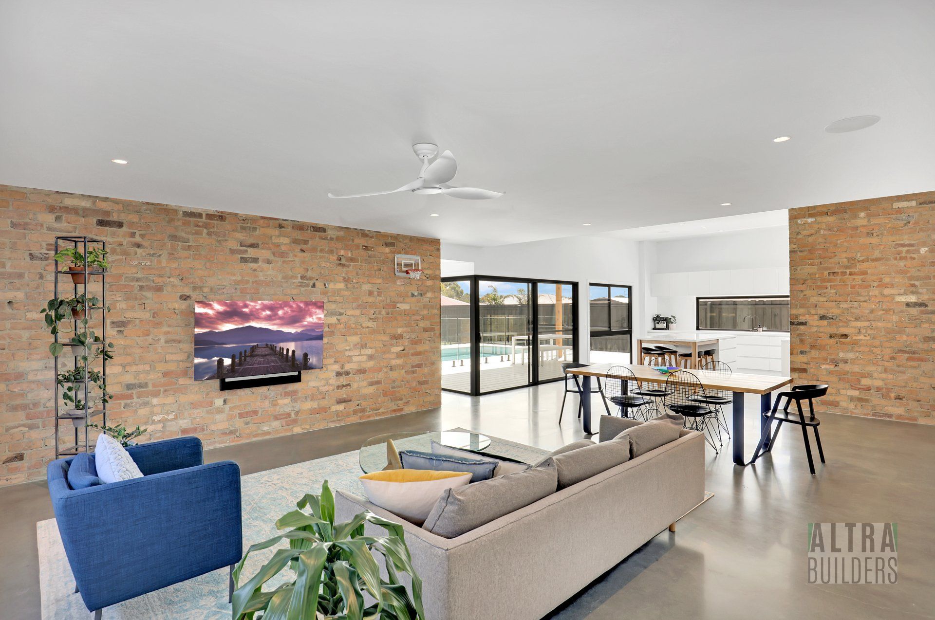 A living room with a couch , chairs , table and television.