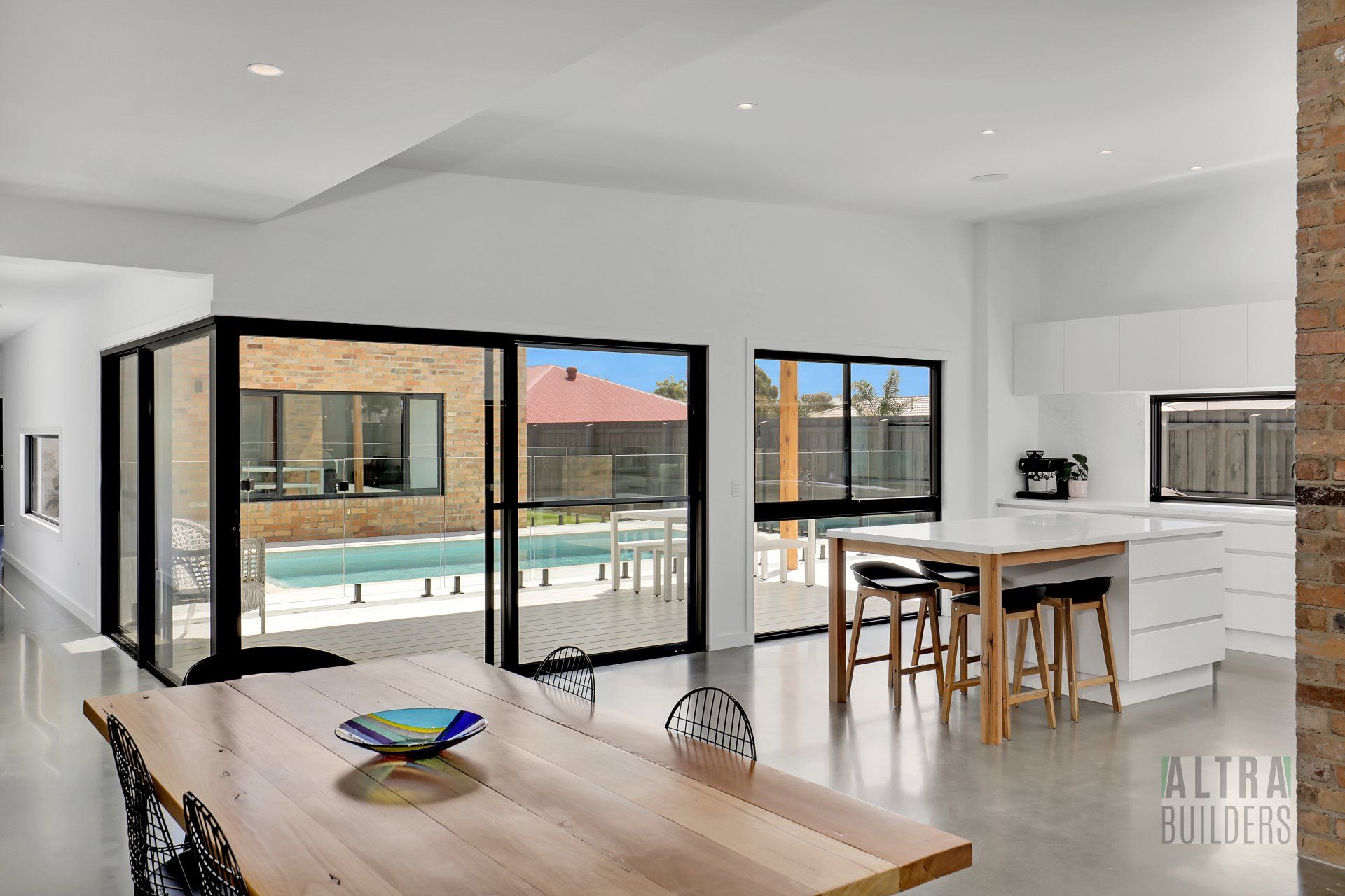 There is a table and chairs in the middle of the room.