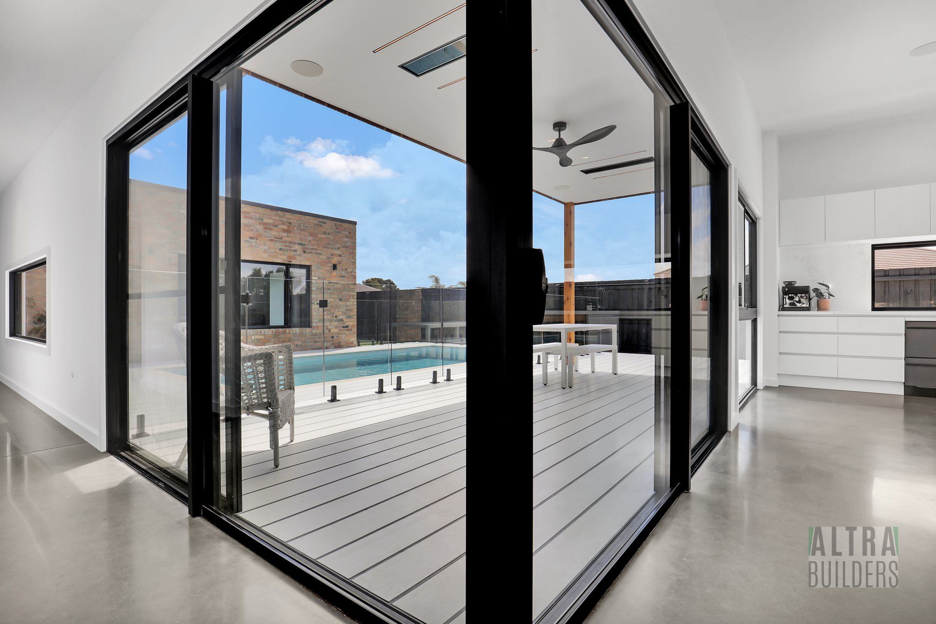 A house with a large sliding glass door leading to a deck